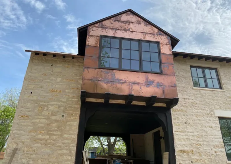 Copper metal panel facade on a stone building for Skylight Installation in New Carrollton